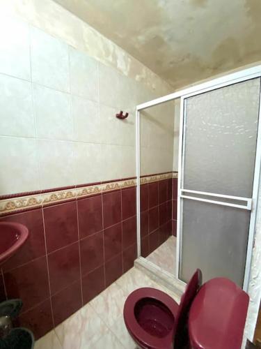 uma casa de banho com um WC vermelho e um chuveiro em 2023 Apartamento Amoblado 4 Habitaciones Familias- Grupos 8 a 9 Personas em Santa Marta