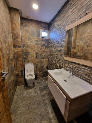 a bathroom with a sink and a toilet at Vill9 in Sidi Rahal