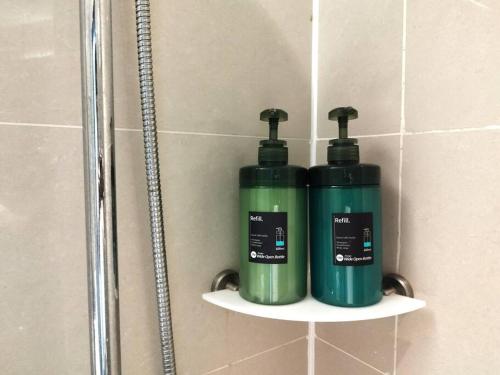 two green bottles on shelves in a shower stall at PJ13 1ooMbpsSweetSty3Pax at PJCentrestage in Petaling Jaya