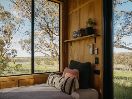 a room with a couch and large windows at CABN Clare Valley in Mintaro