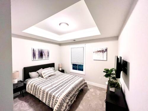 a white bedroom with a bed and a window at Pink Sand Hideaway in Hilton Head Island