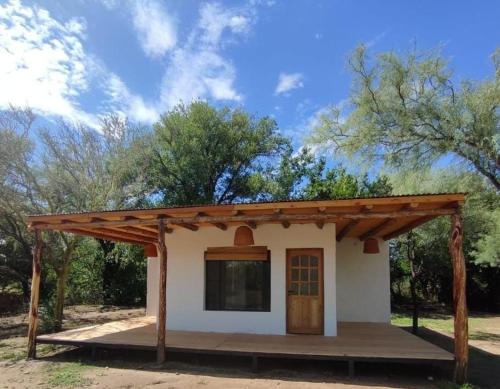 a small house with a wooden roof at Saucearriba, Saucelinda. in Villa Dolores