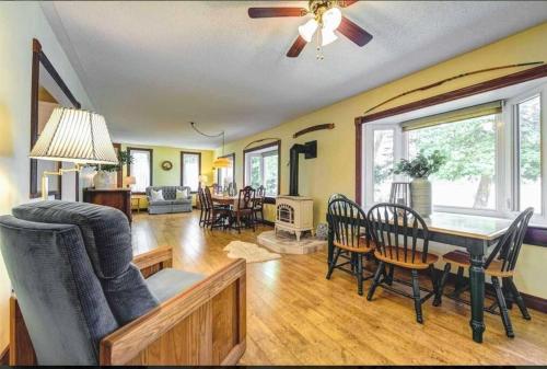 a dining room and living room with a table and chairs at Rustic Pines Waterfront Cottage *CLEAR WATER* in Fenelon Falls