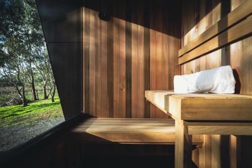 a wooden sauna with a wooden bench and a window at CABN McLaren Vale in McLaren Flat