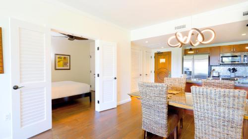 a kitchen and dining room with a table and chairs at Honua Kai - Konea 312 Mountain View 2BR/1BA in Kaanapali