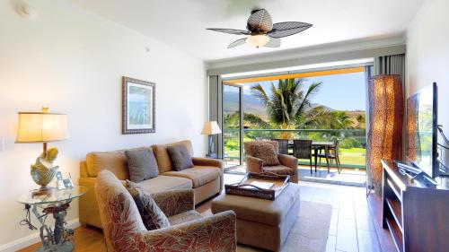 a living room with a couch and a tv at Honua Kai - Konea 312 Mountain View 2BR/1BA in Kaanapali