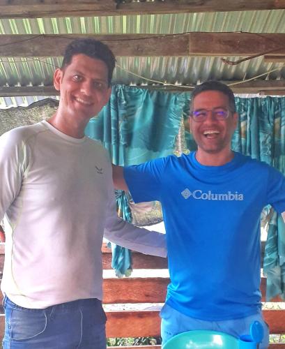 two men are standing next to each other at House of TamSe Laagans ' Inn in Badian