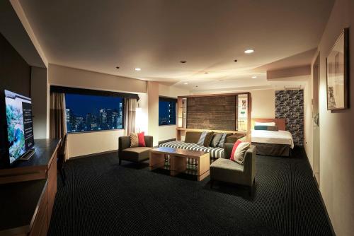 a large hotel room with a bed and a television at Hotel New Otani Tokyo Garden Tower in Tokyo