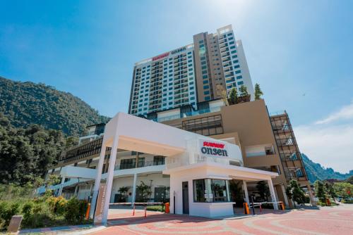 a building in front of a tall building at Ipoh Tambun Lost World Sunway Onsen Suites Lana 2R2B 8 paxs in Tambun