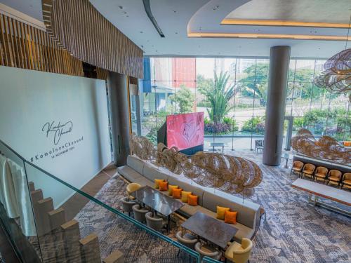 a lobby of a building with chairs and a table at Chatrium Grand Bangkok in Bangkok