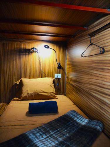 a bedroom with a bed with a light on it at Leveli Coliving in Guadalajara