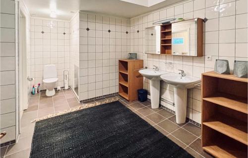 a bathroom with two sinks and a toilet at Lovely Apartment In Henn With Wifi in Henån