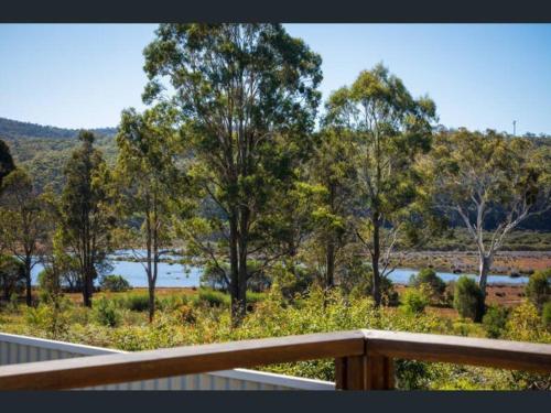 a view of a lake from a deck at Top of the Lake Holiday Units in Merimbula