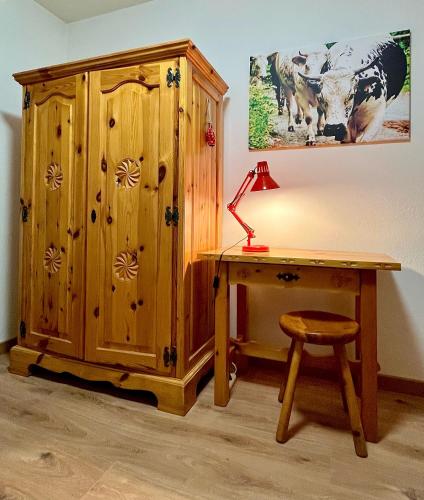 a desk with a lamp next to a wooden cabinet at Alpine Vista Villa Hardaker 4 bedrooms Torgnon in Torgnon