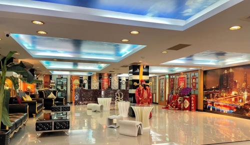a lobby of a store with couches and chairs at Wenpin Hotel - Pier 2 in Kaohsiung