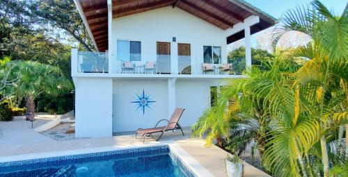a villa with a swimming pool and a house at Villa Azul in Sámara