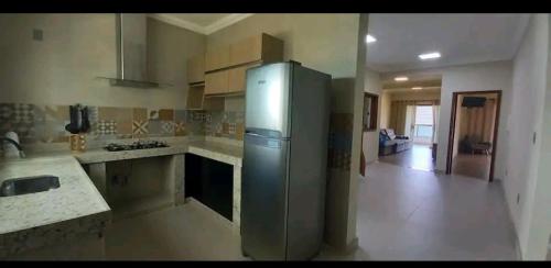 a kitchen with a stainless steel refrigerator in a room at Casa Nova em Ouro Preto e Mariana in Ouro Preto