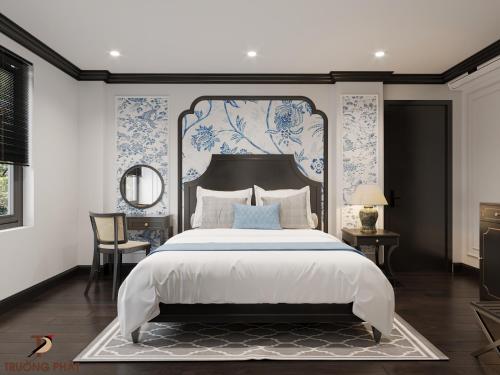a bedroom with a large bed with blue and white wallpaper at HƯỚNG DƯƠNG HOTEL THANH HOÁ in Thanh Hóa