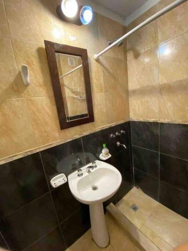 a bathroom with a sink and a mirror at Departamento Gallino in Corrientes