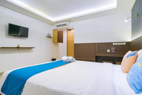 Tempat tidur dalam kamar di Sans Hotel Rumah Kita Daan Mogot by RedDoorz