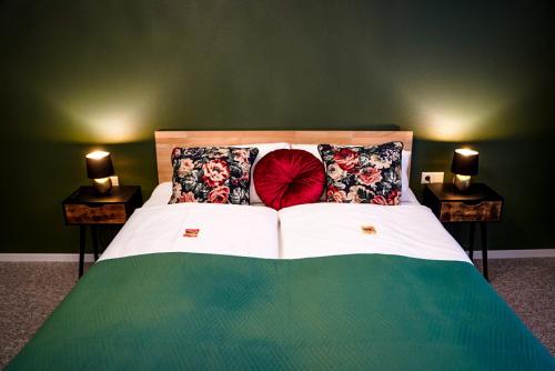 a bedroom with a bed with two night stands at Hotel Residenz Luxury - Outletcity - Parken - Klima - 24h Check-In in Metzingen
