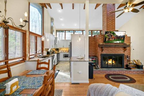 a kitchen and a living room with a fireplace at Pocono Pines, Lake Naomi 4 bedrooms, 2 full bath in Pocono Pines