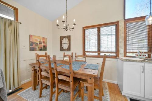 a dining room with a wooden table and chairs at Pocono Pines, Lake Naomi 4 bedrooms, 2 full bath in Pocono Pines