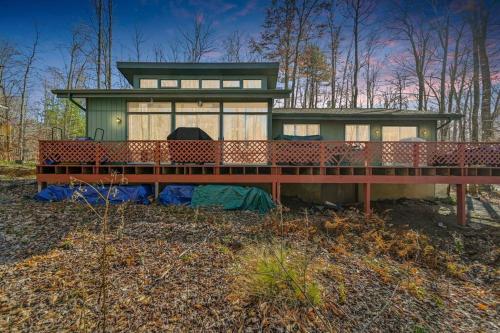 a house with a large deck in the woods at Pocono Pines, Lake Naomi 4 bedrooms, 2 full bath in Pocono Pines