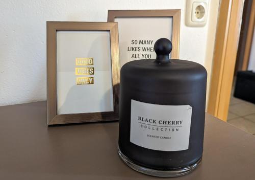 a bottle of black cherry coefficient sitting on a table next to a mirror at FeWo Goldstück mit privatem SPA und Whirlpool in Grafenau