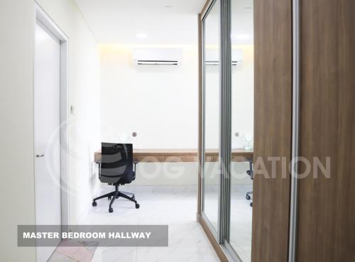 an office with glass doors and a black chair at Lovely 3-bedrooms with Karaoke Genting Penthouse in Genting Highlands