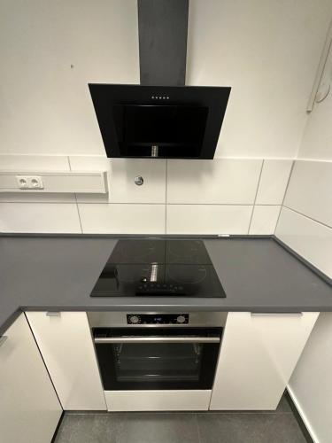 a kitchen with a tv on top of a counter at EasyLiving Darmstadt in Darmstadt