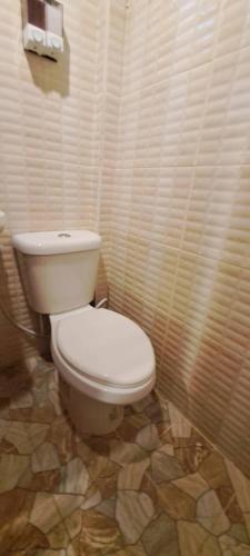 a bathroom with a white toilet in a room at DGD Chiangmai in Mae Rim