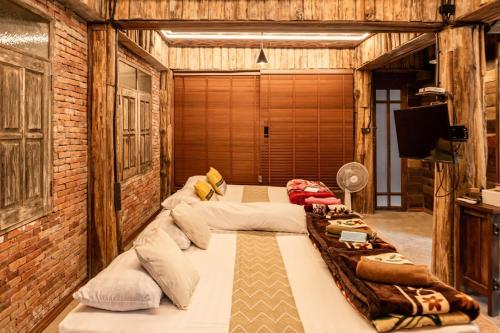 Ban Pok Naiにあるไชยพล โฮมสเตย์ หมู่บ้านแม่กำปองの広い客室で、ベッド3台が備わります。