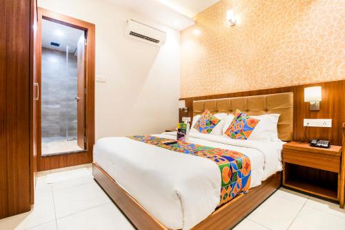 a hotel room with a bed and a window at FabHotel Prime Le Western in Mumbai