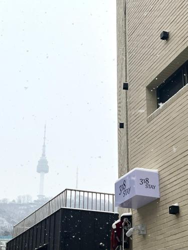 a street sign with the eiffel tower in the background at 318 Stay in Seoul