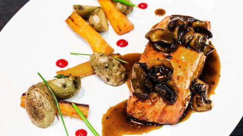 a plate of food with meat and vegetables on it at Holiday Inn Rosario by IHG in Rosario