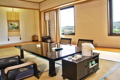 a office with a desk and chairs in a room at Hotel City Plaza Kitakami in Kitakami