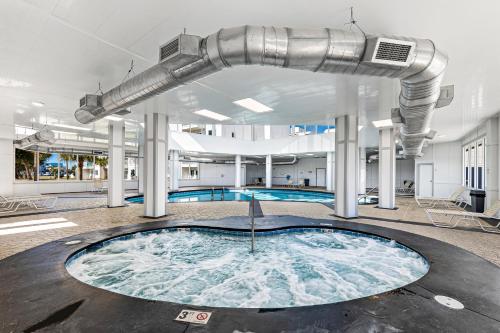 a large swimming pool in a building with a large pipe at Plantation 2308 in Gulf Shores
