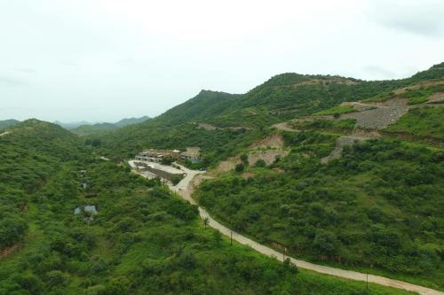 a winding road on the side of a mountain at StayVista's Sage Scenery - Mountain-View Villa with Infinity Pool & Terrace in Udaipur