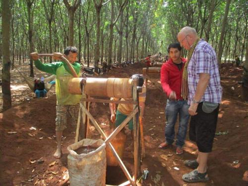 a group of people standing around a well in the woods at Banlung Mountain View Treks & Tours in Banlung
