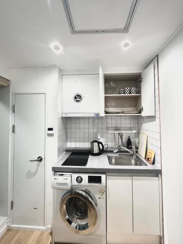 a kitchen with a washing machine and a sink at 318 Stay in Seoul