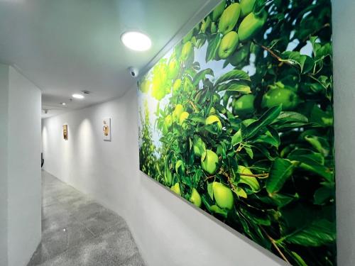 a wall with a painting of a tree at 318 Stay in Seoul
