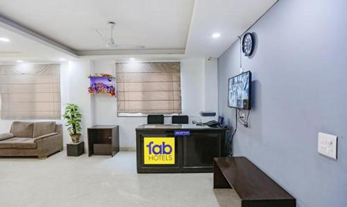 a living room with a tv and a couch at FabExpress Dream Living in New Delhi