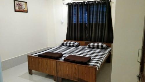 a bed in a room with a black curtain at New Bombay Lodge in Nagpur