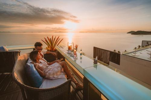 InterContinental Koh Samui Resort, an IHG Hotel في شاطئ تالينغْنام: جلوس زوجين في بار على سطح يخت