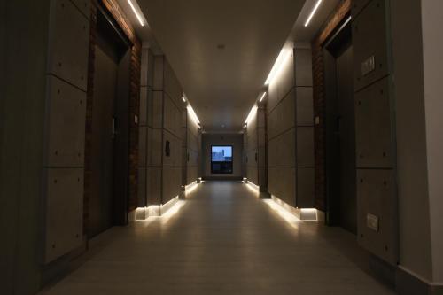 an empty hallway in an office building with lights at RATHNA RESIDENCY - Near US CONSULATE in Chennai