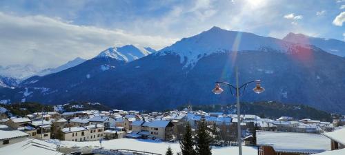 a view of a city with a snow covered mountain at Fleur et Benj in Aussois