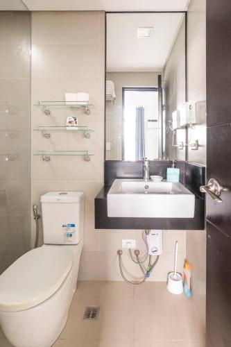 a bathroom with a white toilet and a sink at QUIET HOME with private beach in Boracay