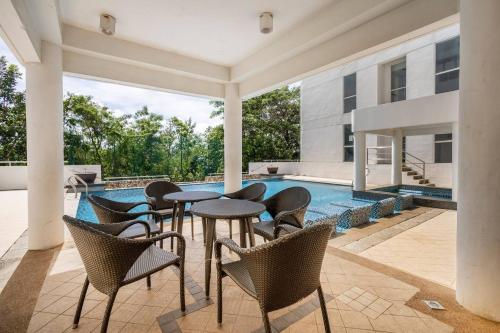 a patio with tables and chairs next to a swimming pool at QUIET HOME with private beach in Boracay