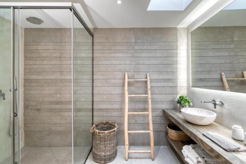 a bathroom with a ladder next to a sink and a shower at M - Mykonos Villas in Tourlos